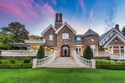 Stone manor estate at 969 Westbend Road at twilight