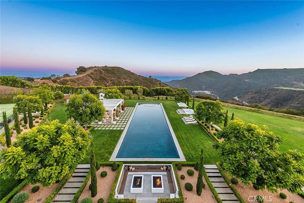 Aerial view of infinity pool overlooking mountains and valley landscape